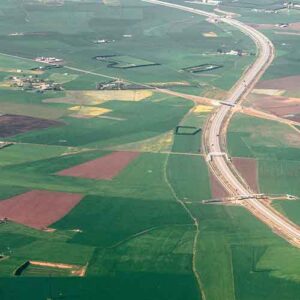 Aerial of green fields with roadways