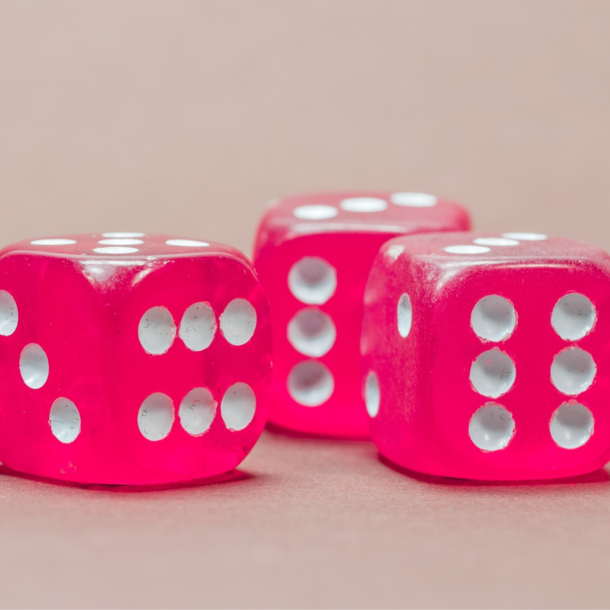 3 pink dice with white pips