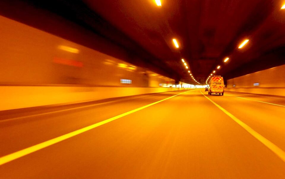 motion shot of van traveling through a tunnel