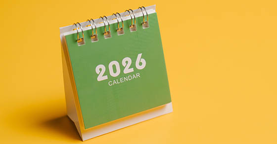 Green miniature standing 2026 calendar with a yellow background.