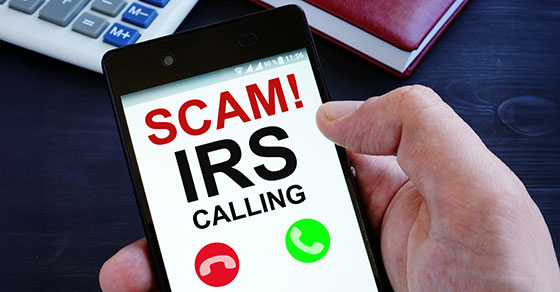 Image of an individual holding a phone and a call coming in reading "SCAM! IRS Calling"