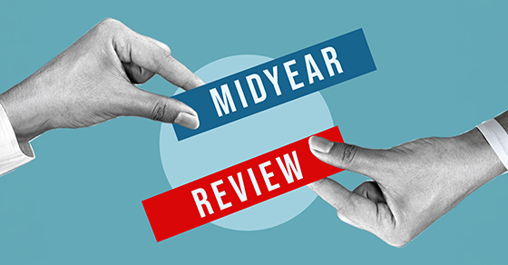 Grayscale hands holding blue and red labels that read "MIDYEAR REVIEW" on a light blue background